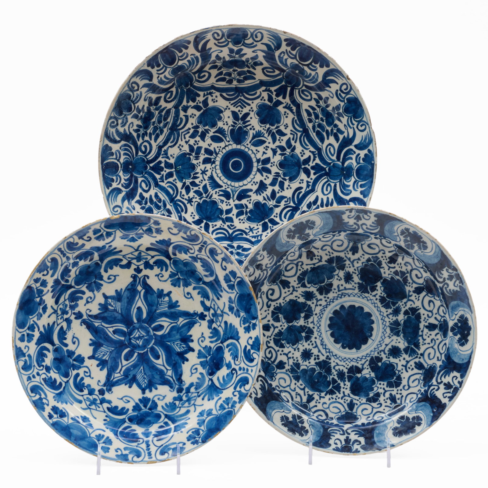 Three Delft Blue and White Chargers: Three Delft Blue and White Chargers Unmarked.The largest 14 in. diam., the smallest 12 in. diam.