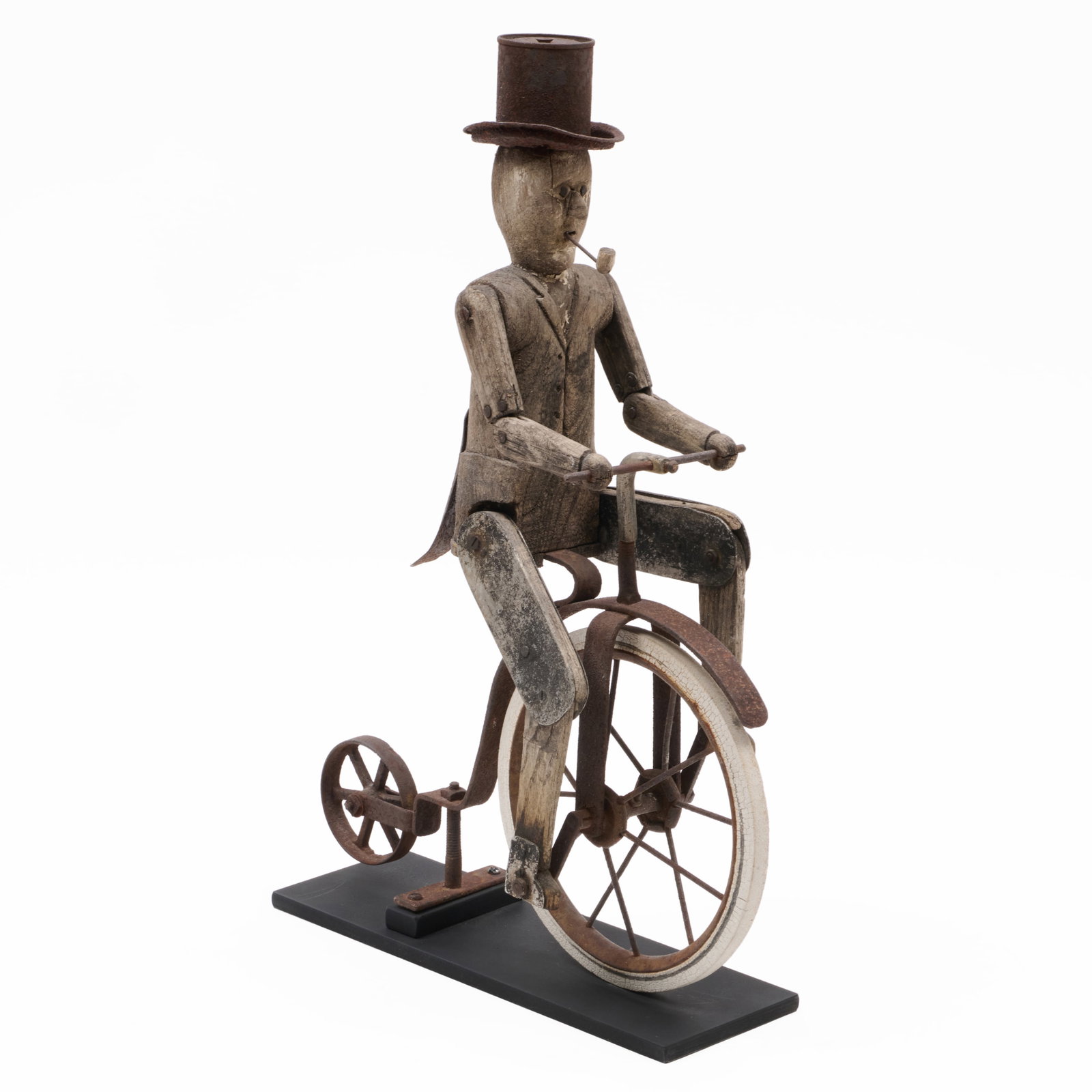 Carved Wood and Cast-Iron Whirligig of a Rider on a Penny-Farthing Bicycle: Carved Wood and Cast-Iron Whirligig of a Rider on a Penny-Farthing Bicycle On custom stand.20 x 4 x 13 1/2 in. (overall). Jim Hirsheimer Vintage Art & Design, Doylestown, PA, October 1995. Property