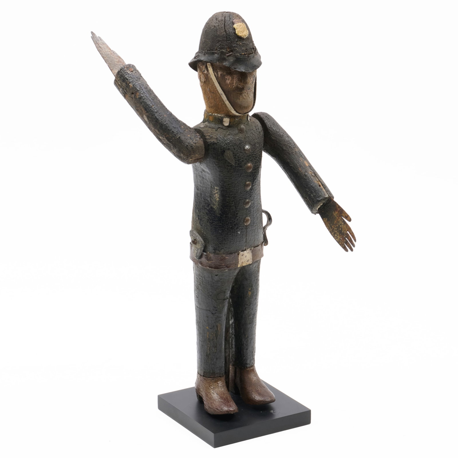 Carved Polychrome Wood and Sheet Metal Whirligig of a Policeman: Carved Polychrome Wood and Sheet Metal Whirligig of a Policeman On custom stand.19 3/4 x 5 x 5 in. (overall). Betty & Joel Schatzberg American Folk Art, Riverside, CT, 1995. Property from the Estate