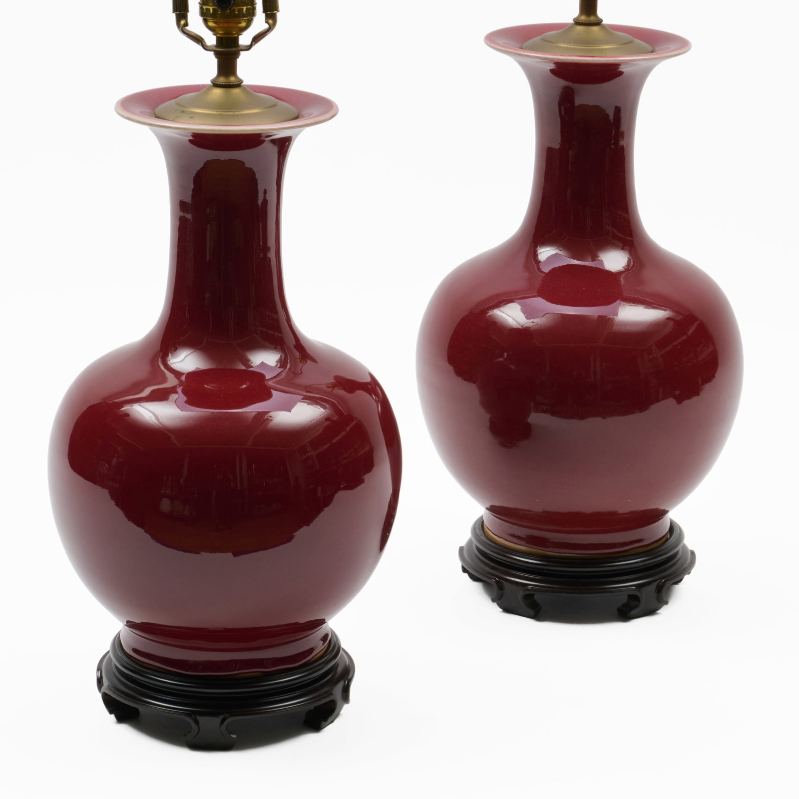 Pair Of Chinese Copper Red Glazed Porcelain Vases Mounted As Lamps: Pair Of Chinese Copper Red Glazed Porcelain Vases Mounted As Lamps The vases 14 x 8 in. diam.; 19 1/2 x 8 in. diam. (to socket).