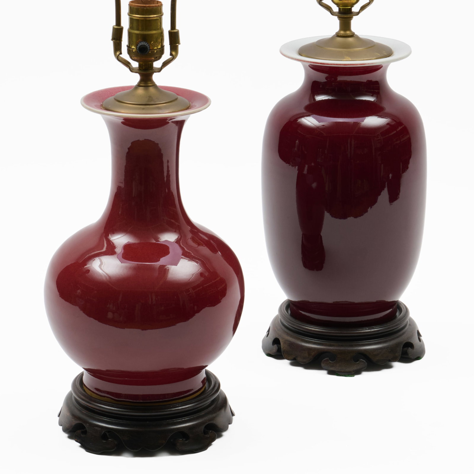 Two Chinese Copper Red Glazed Porcelain Vases Mounted As Lamps: Two Chinese Copper Red Glazed Porcelain Vases Mounted As Lamps The larger 11 1/2 x 6 1/2 in. diam., 16 1/2 x 6 1/2 in. diam. (to socket).