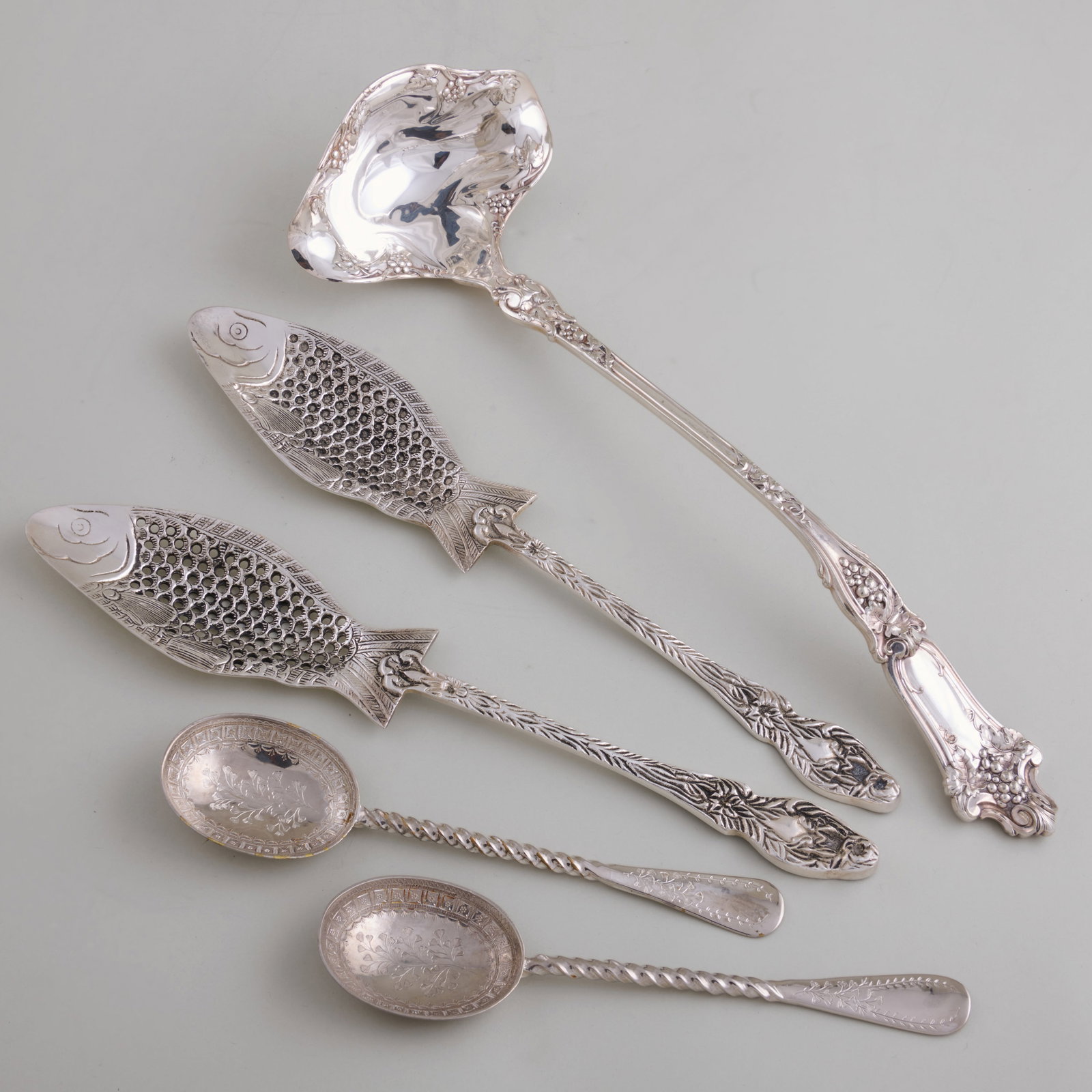 Two Pairs of Russian Silver Plate Servers: Two Pairs of Russian Silver Plate Servers Comprising a fish form pair and an engraved pair with twist handlesTogether with a Wallace silver plate punch ladle.The largest 15 1/4 in. (5 pcs). Collection