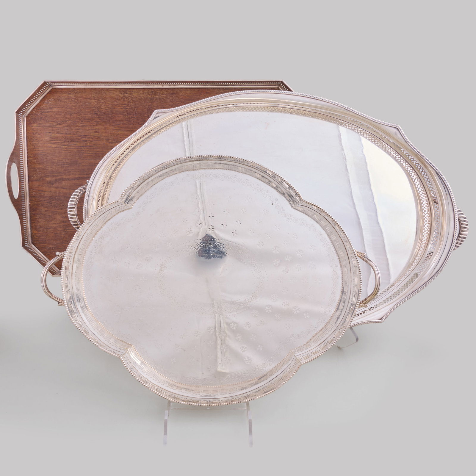 Two Silver Plate Trays and a Victorian Plate-Mounted Mahogany Tray: Two Silver Plate Trays and a Victorian Plate-Mounted Mahogany Tray The largest 27 3/4 x 17 in., (3 pcs). Collection of Marlo Thomas and Phil Donahue, New York.