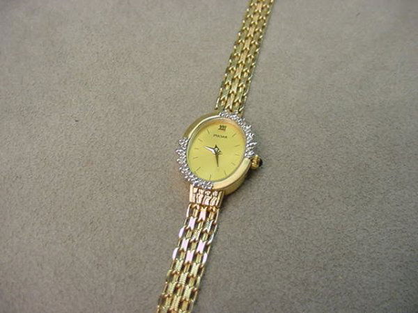 14K GOLD LADIES PULSAR WRISTWATCH -DIAMOND: 1 LADIES PULSAR WRISTWATCH IN 14K GOLD CASE SET WITH DIAMOND ON 14K GOLD BAND--7 1/4 INCH - GRAM WEIGHT: 11.9