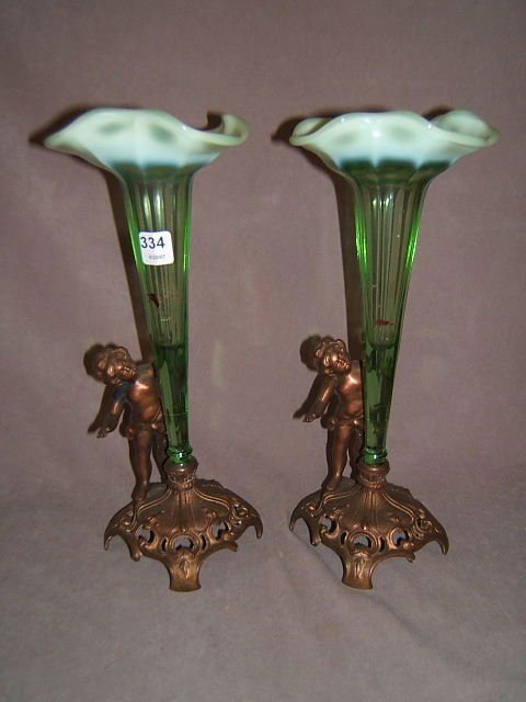 2 BRONZE FIGURAL EPERGNES WITH GLASS TRUMPETS: 2 BRONZE FIGURAL EPERGNES WITH OPALESCENT GLASS TRUMPETS - 13 1/4" HIGH, 4" SQUARE BASE, FINISH WEAR/DAMAGE, HOLES TO BACK OF HEADS, INTERIOR STAINS, NOT ORIGINAL PIECES?