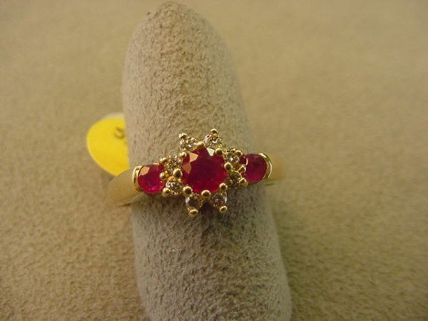 10K GOLD RUBY AND DIAMOND RING: 1 10K GOLD RING SET WITH 3 ROUND RUBIES & 8 DIAMONDS SIZE 7 - GRAM WEIGHT: 2.9