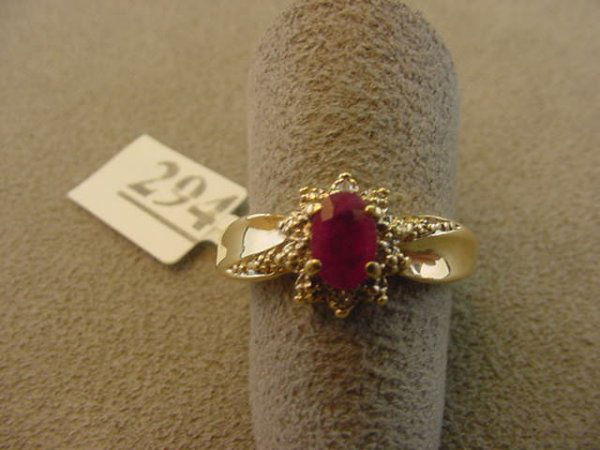 10K GOLD RUBY AND DIAMOND RING: 1 10K GOLD RING SET WITH 1 OVAL RUBY & 2 DIAMONDS SIZE 6 1/2 - GRAM WEIGHT: 2.5