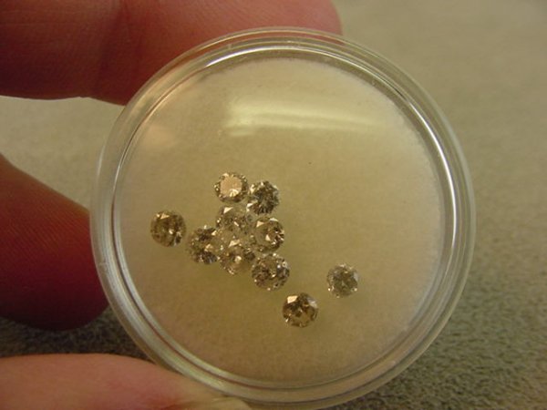 10 UNSET ROUND DIAMONDS TOTALLING APROX .70 CTS