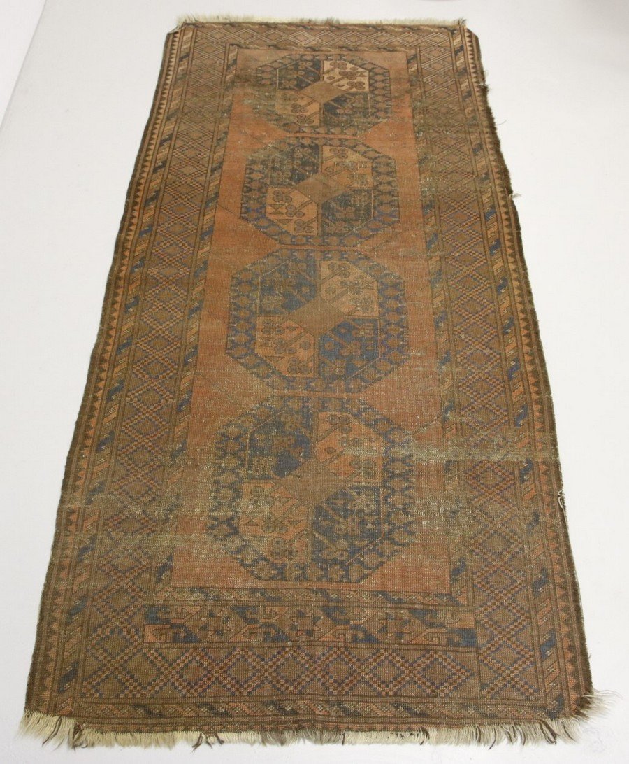 Turkoman Runner Rug: Predominant rust brown color with blues and browns. Four octagonal medallions with rust backgrounds field and blue outer boarders. Main border with checkered diamond pattern with inner boarder. 95" X