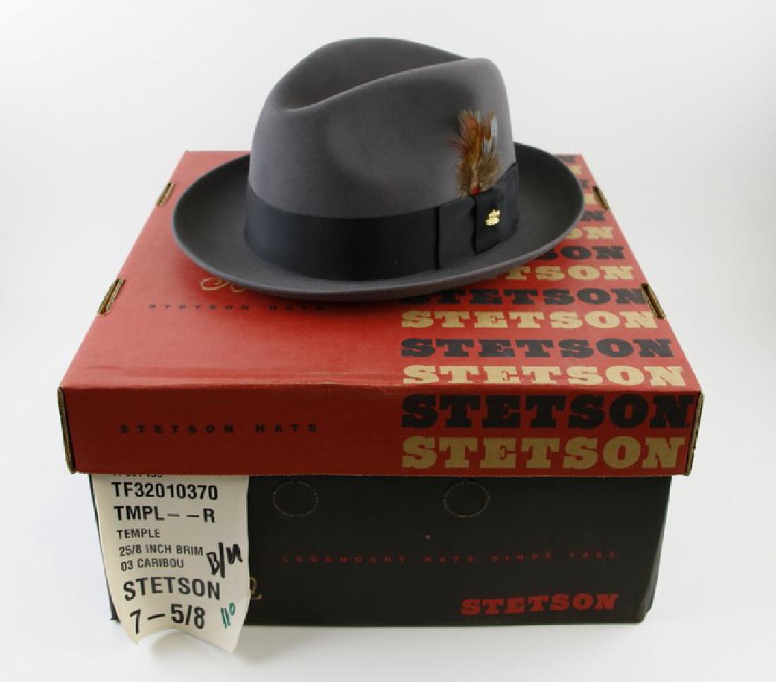 Hat - Stetson Fedora Caribou Gray Hat: This Stetson Fedora is made of Premium Wool Felt, with a Grosgrain Ribbon Band and Embellished with Stylish Feather and Gold Stetson Emblem. 7 5/8, 25/8 Brim. Est weight: 2 lbs,