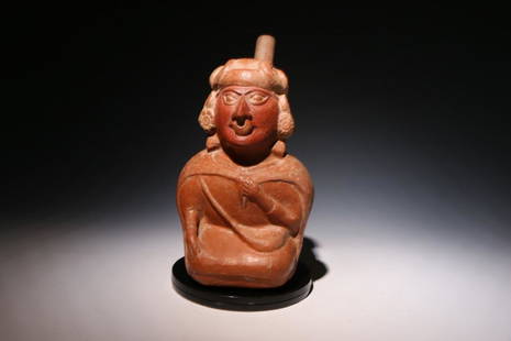 Pre-Columbian Moche Nobleman Stirrup Vessel: Moche Nobleman Stirrup Vessel, Phase IV, circa 200 - 500 A.D. A museum quality Stirrup vessel of a nobleman. The vessel depicts a seating person of high rank with on arm on lap and other hold a