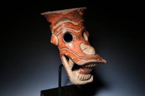 Pre-Columbian Zoomorphic Head â€“ Jaguar: Pre-columbian Jaguar - Costa Rica, ca. 500 - 1000 A.D. A zoomorphic Jaguar Head from a leg of a vessel. The head is polychrome, orange, cream and brown. Openwork eyes and open fang mouth. Protruding n