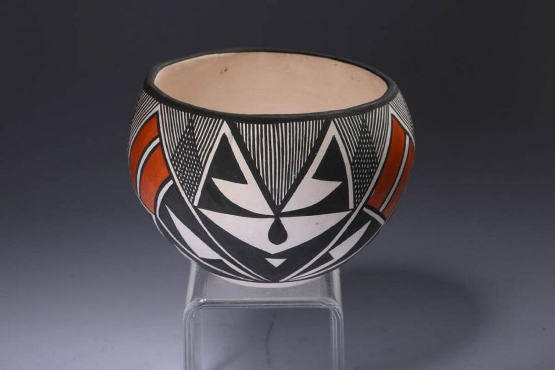 Native American Acoma Pottery: A small Acoma bowl with abstract mountain design. Thin walled. Signed "D. Brown, Acoma NM". Dimensions: 2-1/2" h; Weight:2.6 oz.