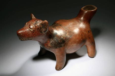 Pre-Columbian Colima Dog: re-Columbian Colima Dog, circa 200 B.C. - 200 A.D. Colima redware dog, nice mineral deposits. Large opening at tail, round belly, large ears, and teeth. Dimensions: 10-1/2" L x 6-1/4" H; weight: 2 lbs