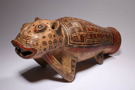 Pre-Columbian Jaguar Drum: A Costa Rican Jaguar Drum, ca. 400 A.D. A large ceramic drum in the shape of a jaguar, broad toothy mouth, eyes, nose and ears, head resting on front paws, cylinder body tapering to large sound openin