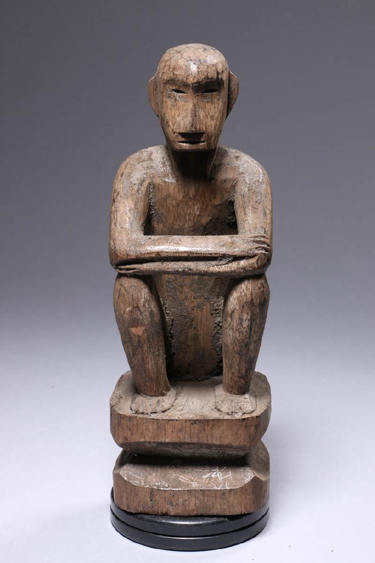 Old Ifugao Standing Bulul, Philippines: Seating Bulul figure, Philippines, seating figure with arms crossed, resting on knees, base in part of the carving. Dimensions: 8" H; Weight: 8.7 oz. Provenance: Ex. Private collection, Queens, NY