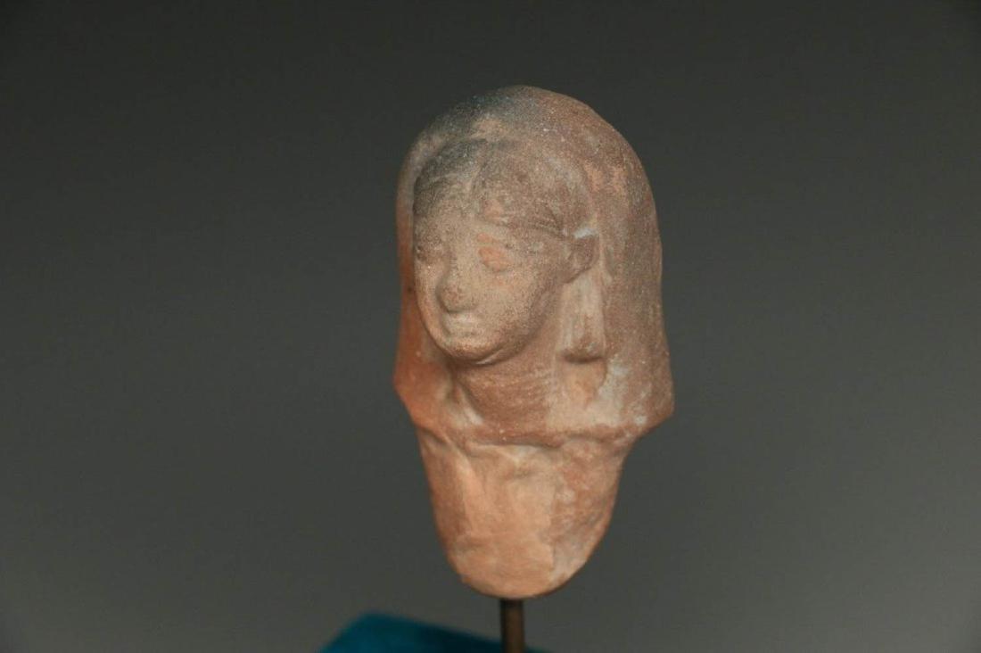 Ancient Egyptian Fertility Figurine 1200 - 539 B.C.: A terracotta fertility figure of a woman with headdress mounted on a display stand. This figure was found in Israel when the land for the Ben-Gurion University was being excavated at biblical Ziklag i