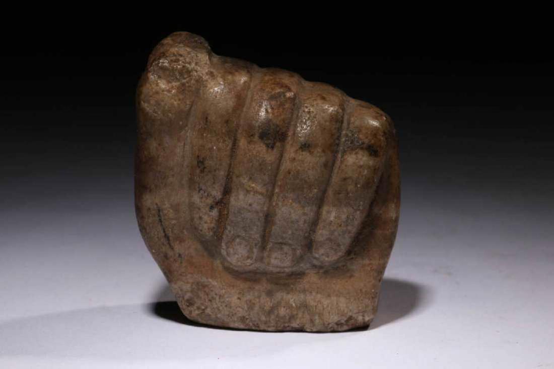 Ancient Egyptian Stone Hand Fragment: Egyptian-Roman Alabaster Hand Fragment circa 100 - 200 A.D. A dark alabaster hand fragment. The hand has folded fingers with thumb at side. Great detail of fingernails and knuckles. Dimensions: 1-5/8"