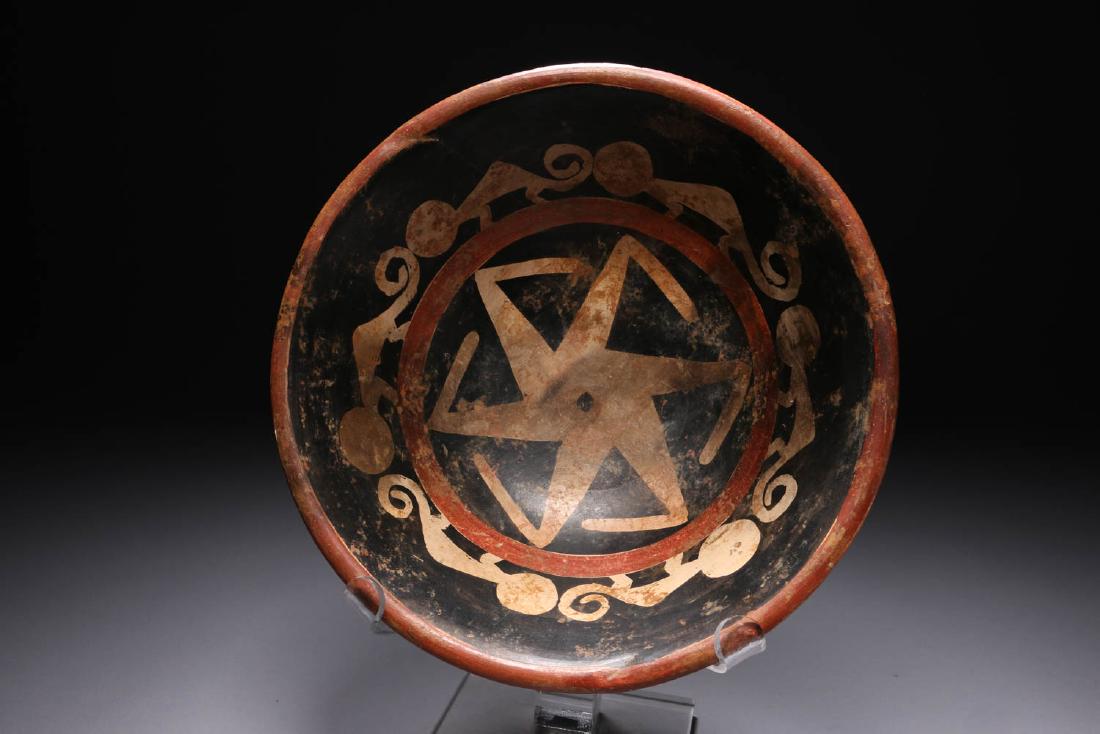Pre-Columbian Narino Bowl - Abstract: Pre-columbian bowl, Narino, Colombian, ca. 50 - 1500 A.D., A wide mouth polychrome pottery bowl with interior design of abstract monkeys and sun burst. Exterior has four triangle designs. Dimensions: 