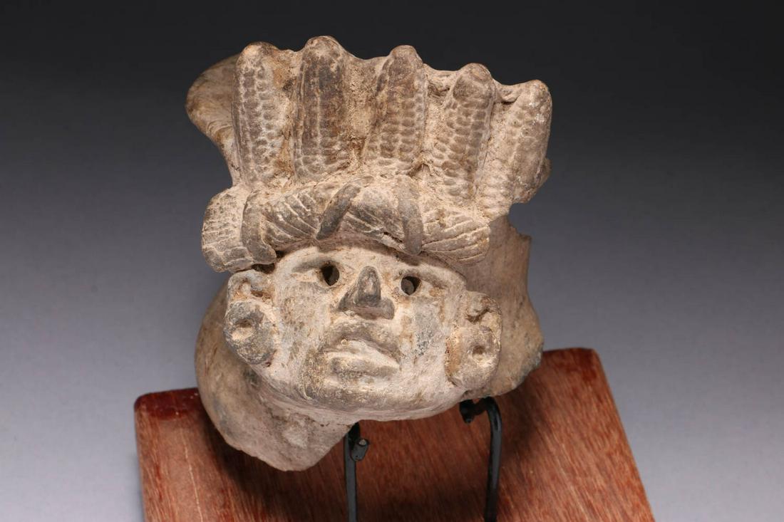Pre-Columbian Corn God: A Zapotec Corn God fragment. Fragment from a bowl, with head and headdress as handle. 5-1/2" w x 5-1/4" H. Display stand is included. Provenance: Ex. Private collection, ME