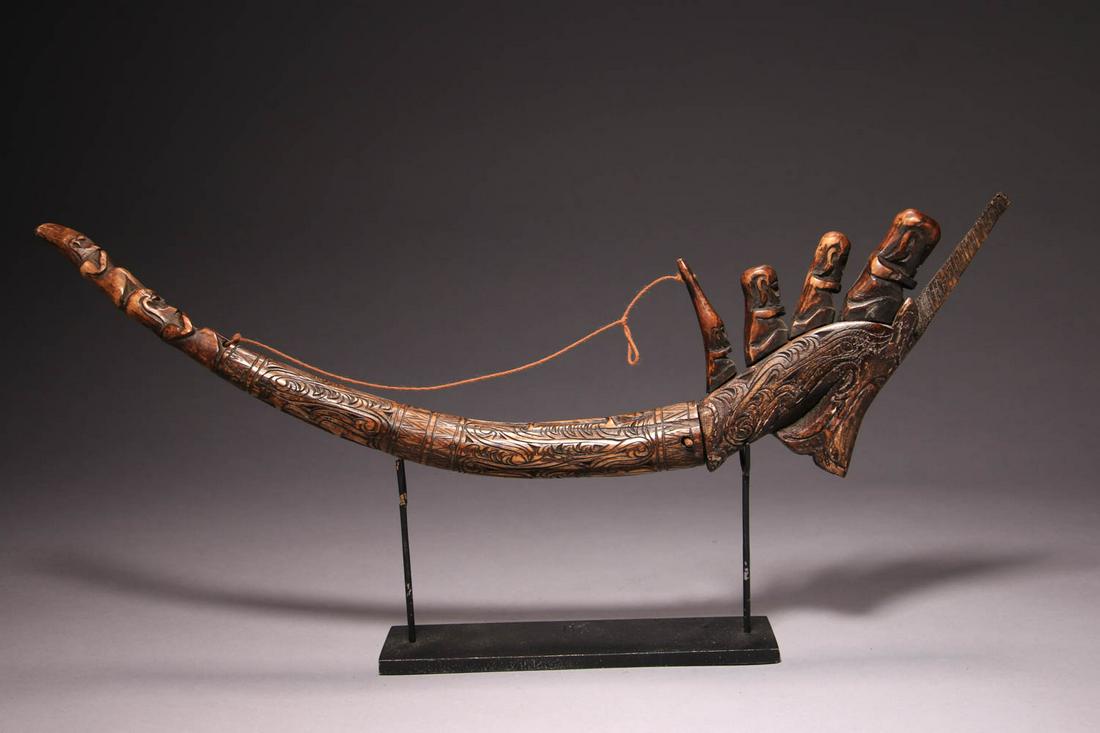 Batak Carved Antler Horn: A carved Buffalo antler container, with ancestor spirits at prow of a boat. Antler locking pin. 17-1/2" L Provenance: Ex private collection, NJ NOTE: This lot has a reserve. Reserve must be met to win