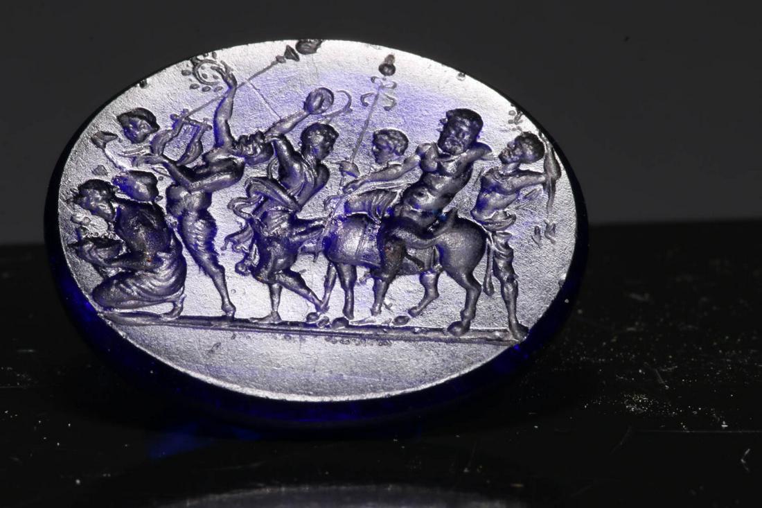Glass Intaglio: A blue glass intaglio of Silenus with followers, 1-1/4" L