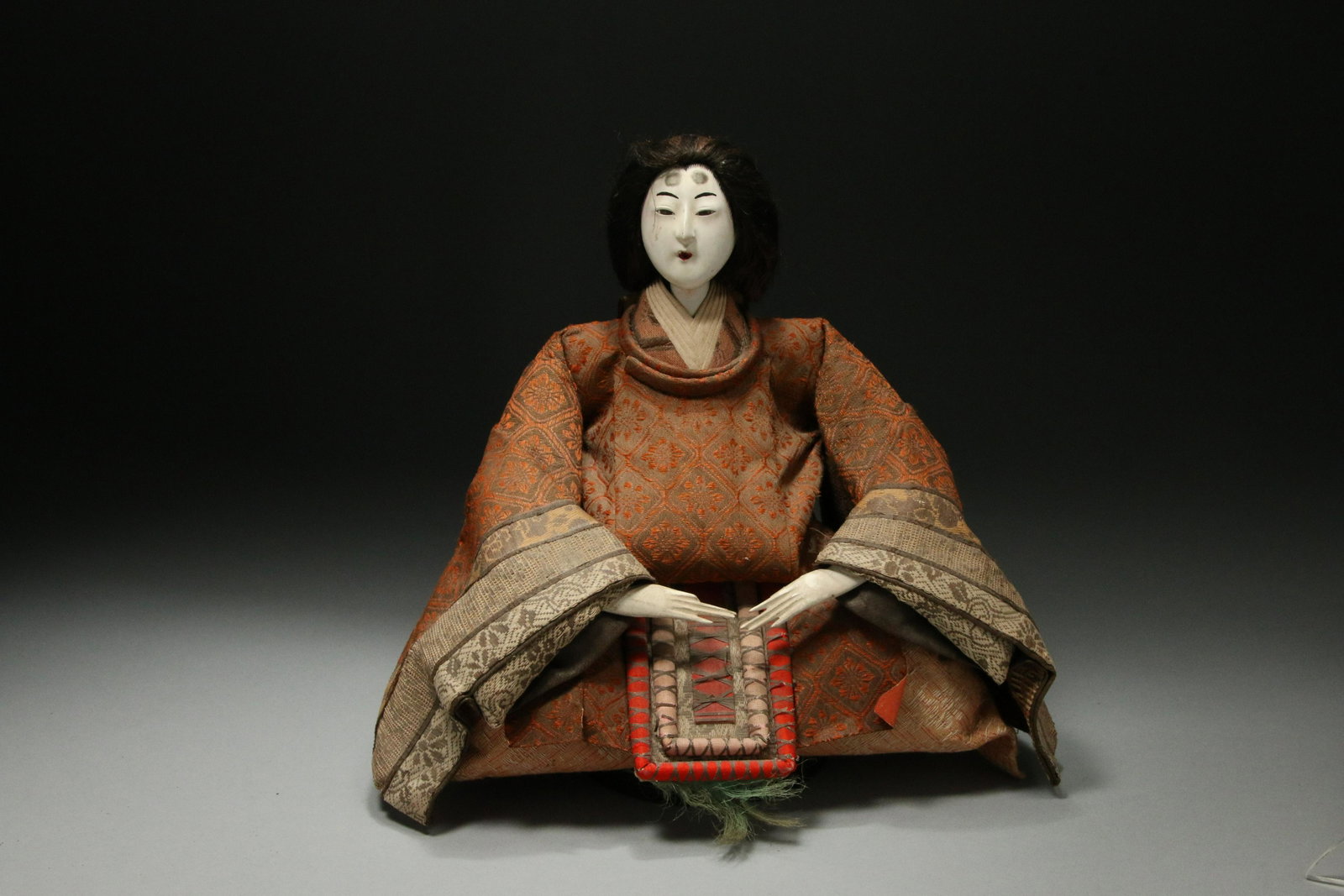 Japanese Doll: A nicely clothed seating doll and white face. 10" H