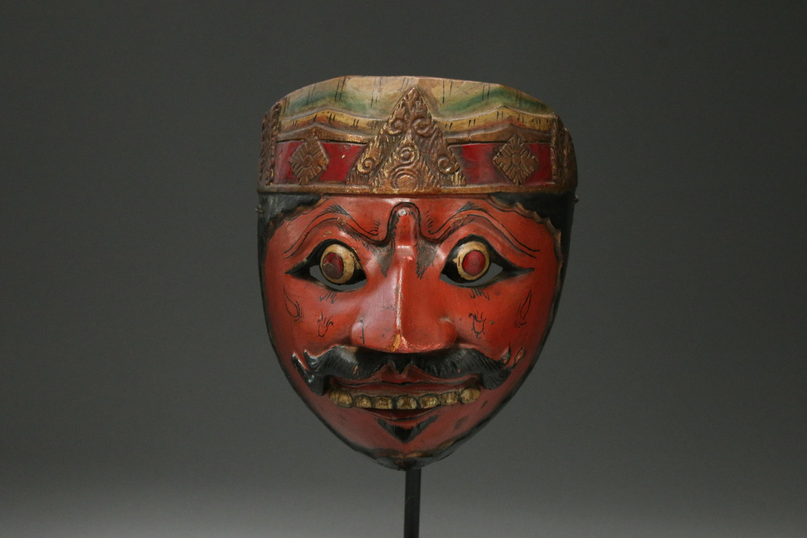 Antique Wayang Topeng Theatre Mask, Indonesia: Antique Javanese carved and polychrome wood mask / wayang topeng, with long nose, moustache, wearing a crown. tongued mouth holder in interior. 7-1/2" H red lips and gold teeth under horse hair mustac