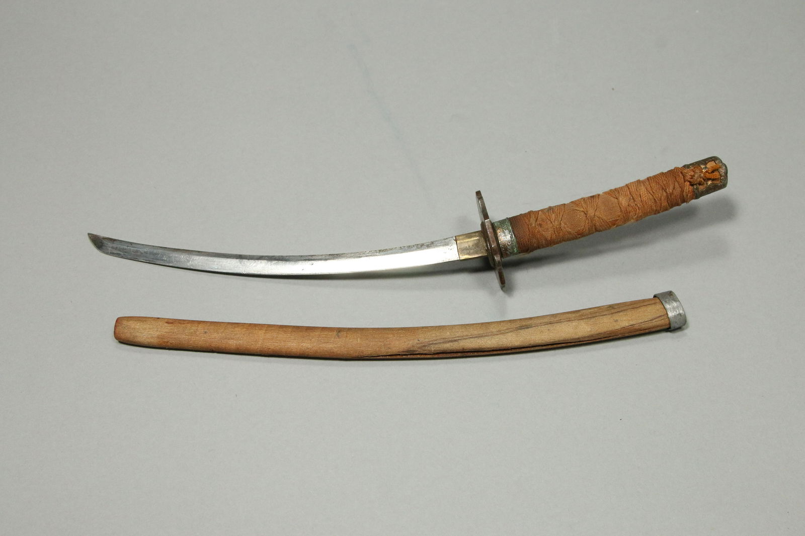 Japanese Letter Opener: An old letter opener with wood sheath, heart design hilt, cloth braided handle. 10" L