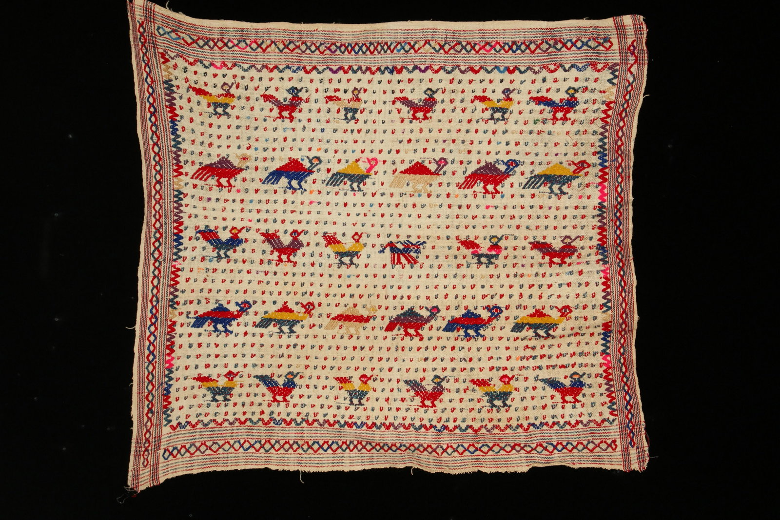 Indonesian Textile: A hand embrodiered cloth, with bird figures. 28" x 25"