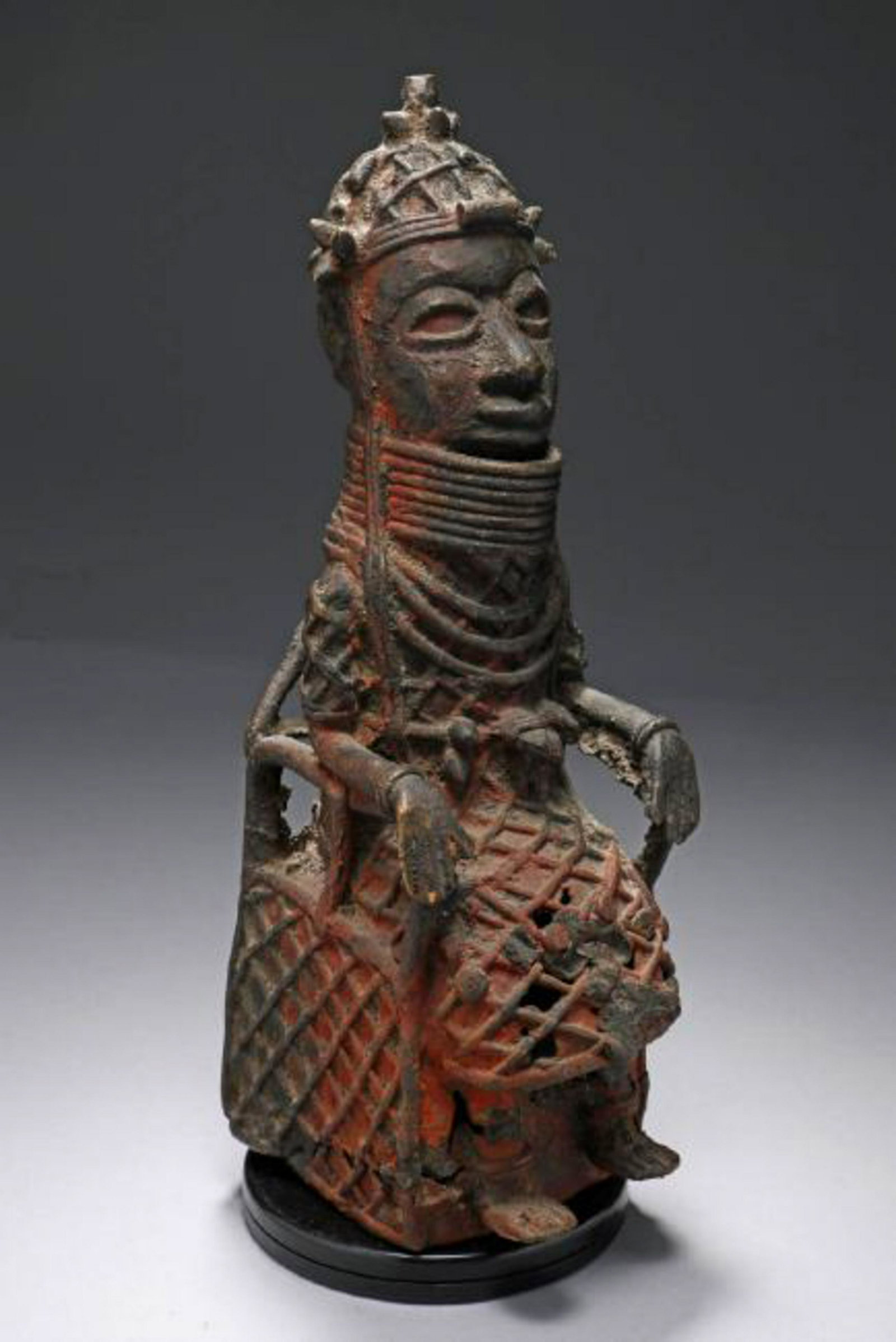 African Art Benin Bronze: A bronze of a chieftan, seating on throne with full regalia. Dimensions: 12" H; Weight: 5 lbs. 14 oz.