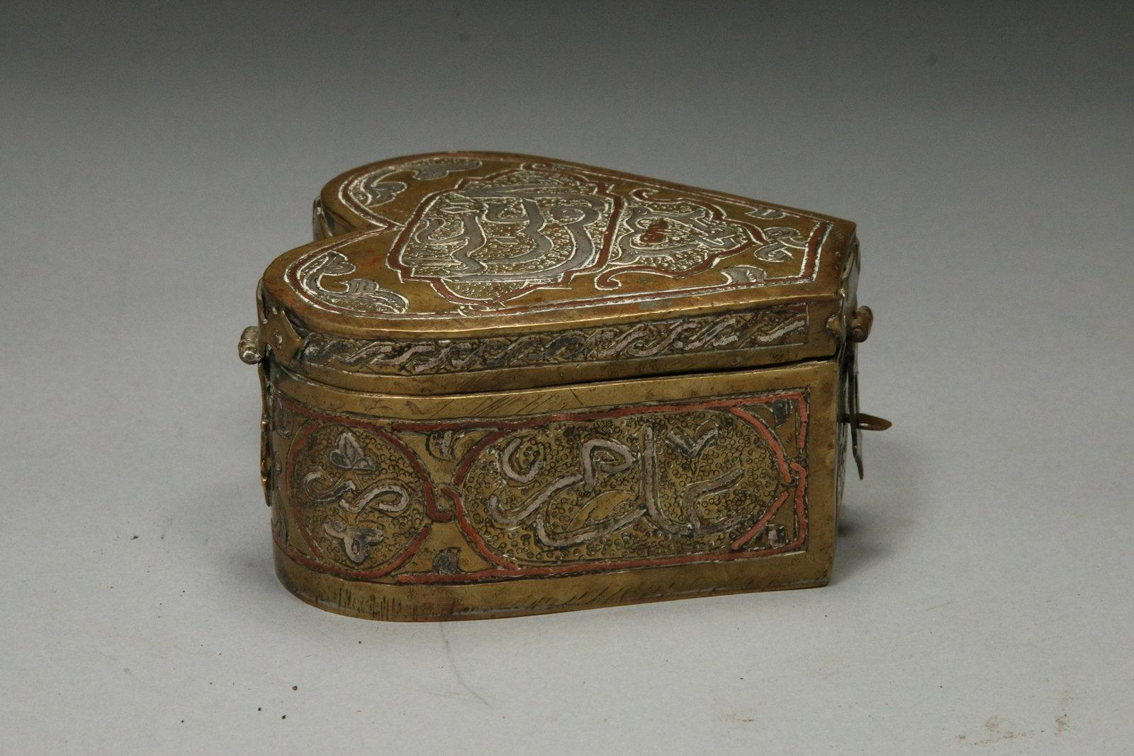 Persian Heart Shaped Jewelery Box: A 19th century silver, copper and mixed metal jewelry box with cedar lining. Islamic writing. 4" L x 3-1/2" W