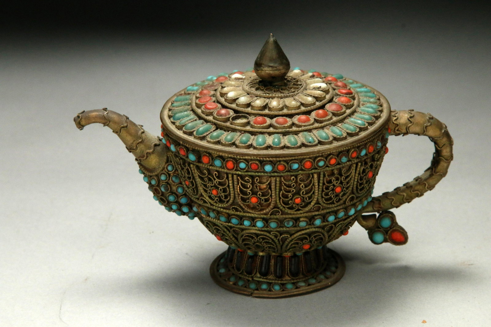 Southeast Asia Tea Pot: A small filigree tea pot with stone inlay. 5" L