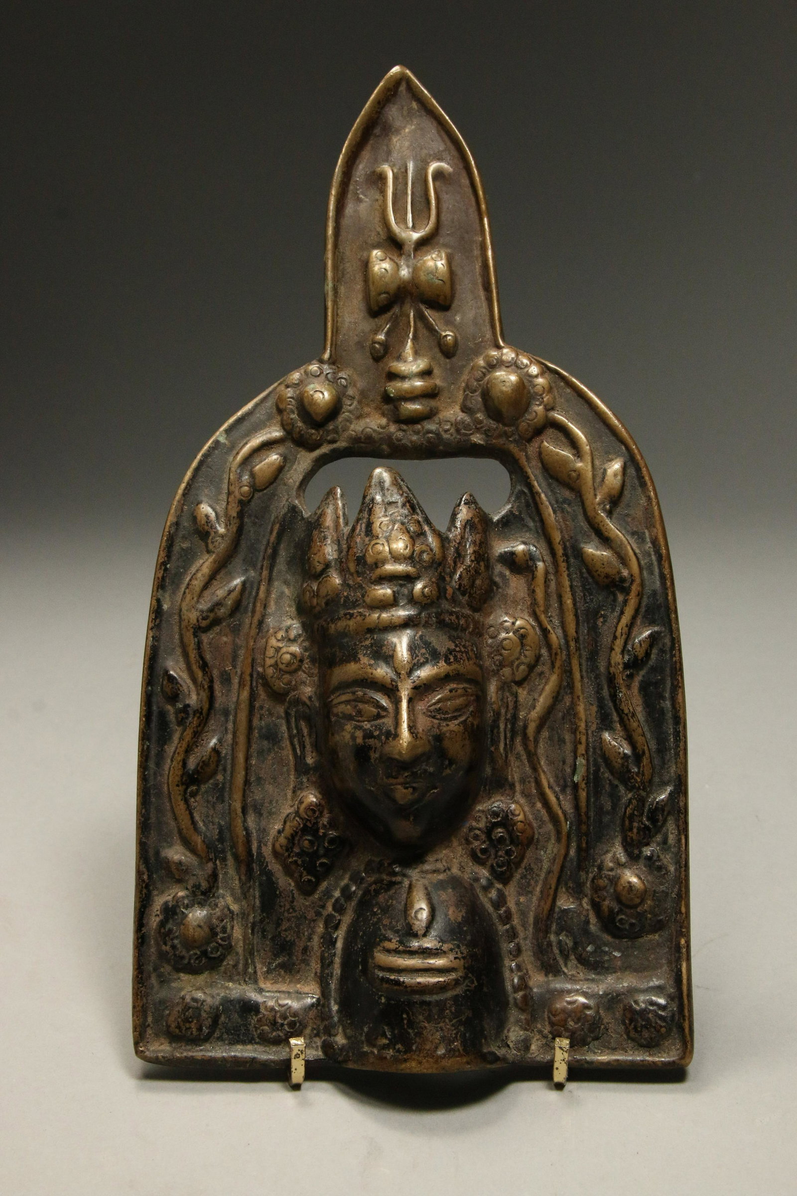 Tibetan Bronze Plaque: A bronze altar plaque with crowned deity. 9-1/2" H