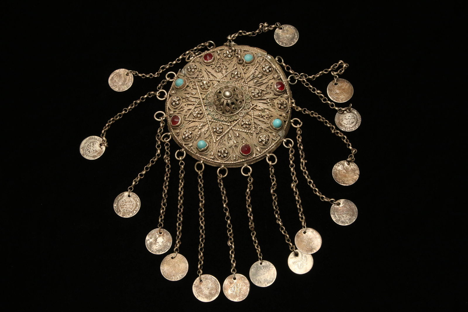 Antique Headdress - Turkmen: A Silver mix metal fez headdress lid with Islamic coin dangles. Glass stones. Measures 4" dia. x 4.5" Long; weighs 157 grams.