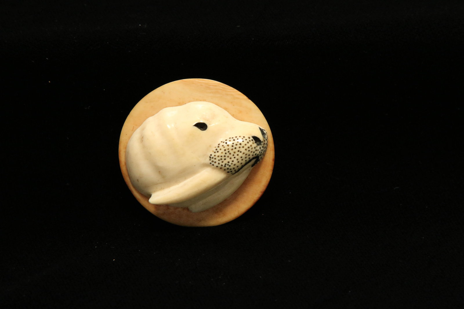Inuit Walrus Tusk Brooch: A vintage carved walrus tusk brooch in the shape of a seal. Measures 1-1/2" H, weighs ---