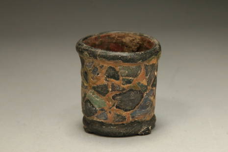 Ancient Roman Mosaic Cup: A Roman mosaic glass cup seating on three legs.