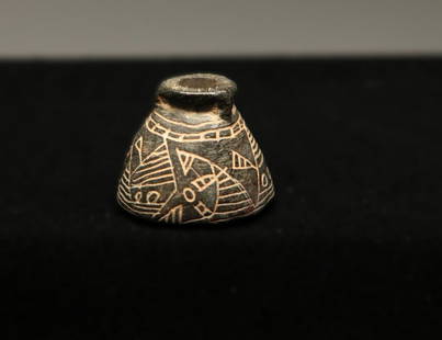 Ancient Spindle Whorl: A stone spindle whorl with incised design.
