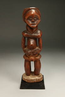 African Art Lumbo Statue: A wood Lumbo statue, great patina, a wonderful carving. 10-1/2" H. Display stand is included. Provenance: Ex. Philips collection, Brussels, Belgium
