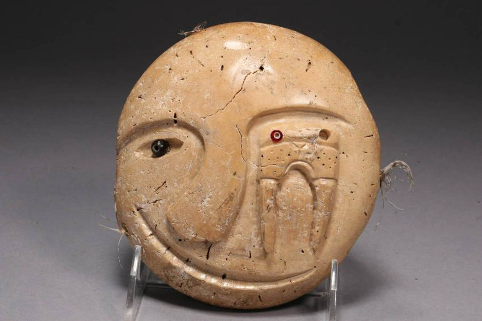 Inuit Art: An carving of an abstract face, signed on back, organic porous material. 5-1/2"X 5"