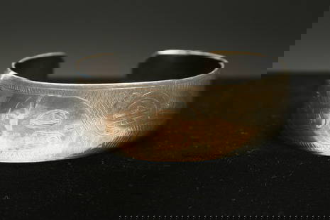 Native American Silver Bracelet - NW Coast: A large silver bracelet with bird and fish design, signed "T…Wins". 30.6 grams; 2-5/8" dia.