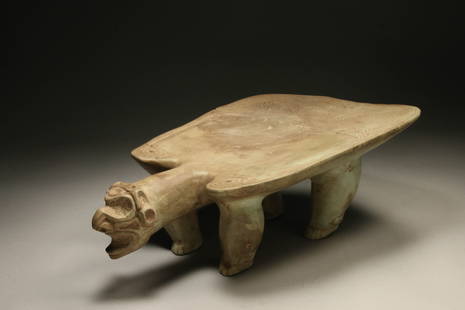 Pre-Columbian Taino Metate: A stone hand carved Metate with an extended Zemi head, incised designs, standing on four carved legs with details. 16" L x 10" W x 5-1/2" H. Provenance: Private Florida, USA collection, Ex