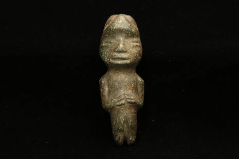 Pre-Columbian Stone Figure: A dark green Guerrero stone figure, with hands at stomach, suspension holes on reverse. 2-3/4" H Provenance: Ex. Collection, New York, NY