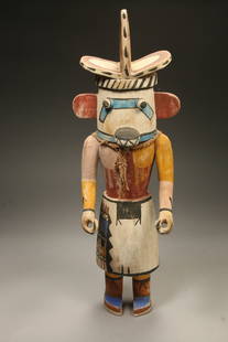 Native American Kachina Doll: A large Hopi Kachina Doll. Cotton wood, articulated arms, polychrome, fiber. 19" H x 5-1/2" W The Hopi carved Kachina Dolls represent their hundreds of ancestral spirits and bring their teachings into