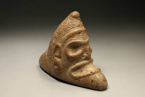 Pre-Columbian Taino Stone Zemi: A stone Zemi with a stylized anthropomorphic skull-like human face. 8-1-2" L x 6-1/2" H x 3-3/4" W; 5 lbs. 13 oz Provenance: Private Florida, USA collection, Ex collection Pierre Fayet,Paris France,