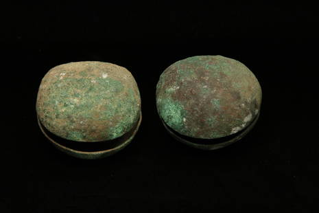 Pre-Columbian Clam Bells - Lot of 2: Lot of 2 bronze clam bells with texture bumps on one side, remains of textile. 2" H