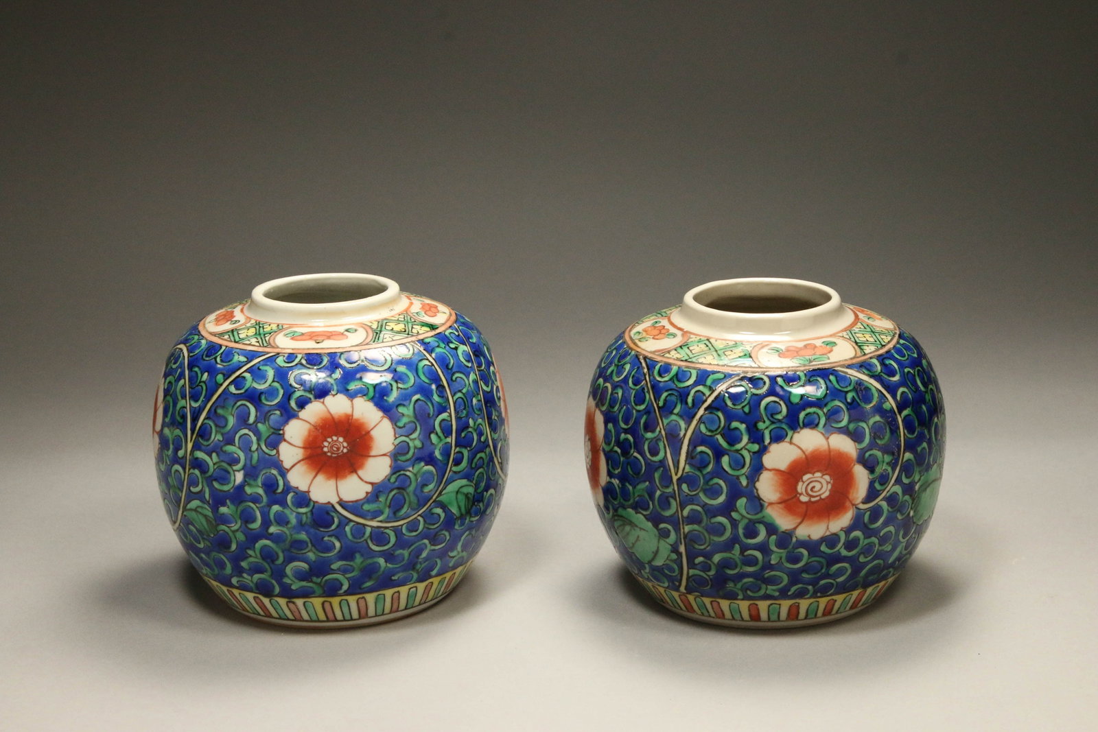 Chinese Ginger Jars - Lot of 2: A pair of ginger jars with flower design. Signed on bottom. 4-1/2" H x 5" dia.