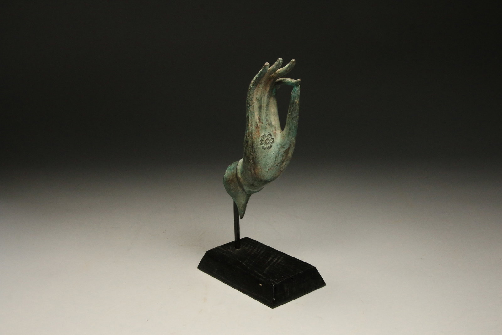 Bronze Buddha Hand with Chakra Flower: An early bronze Buddha hand in the blessing Vitarka Mudra pose. Display stand is included. 8" H