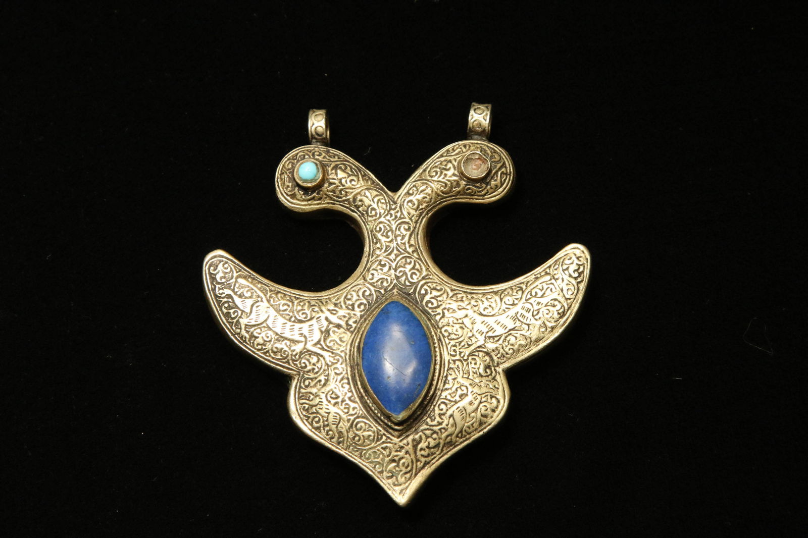 Antique Silver and Stone Pendant: An Afghanistan silver and stone pendant with incised designs, including animals. 2-3/4" H