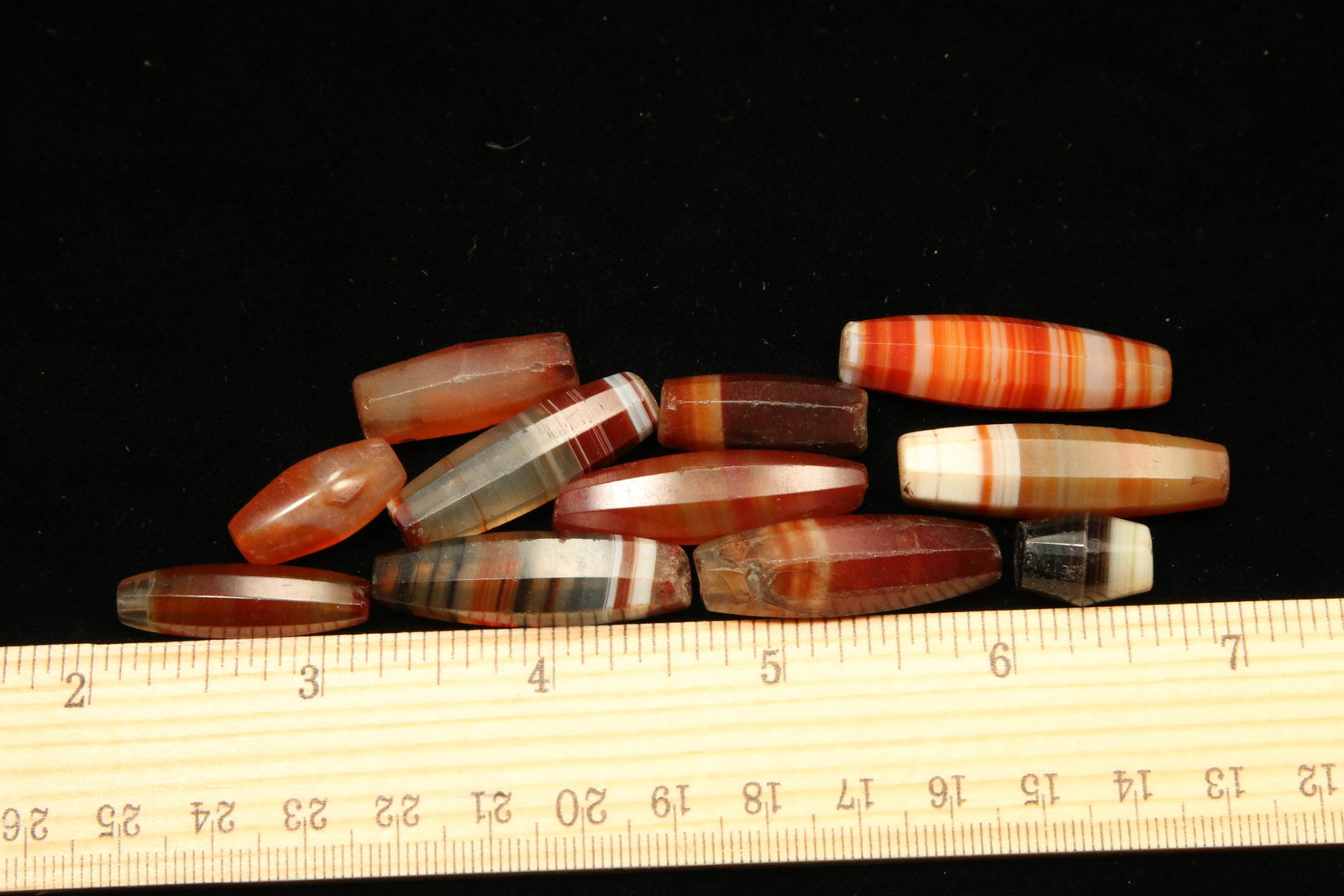 Ancient Carnelian and Banded Agate Beads - Lot of 11: Eleven stone beads.